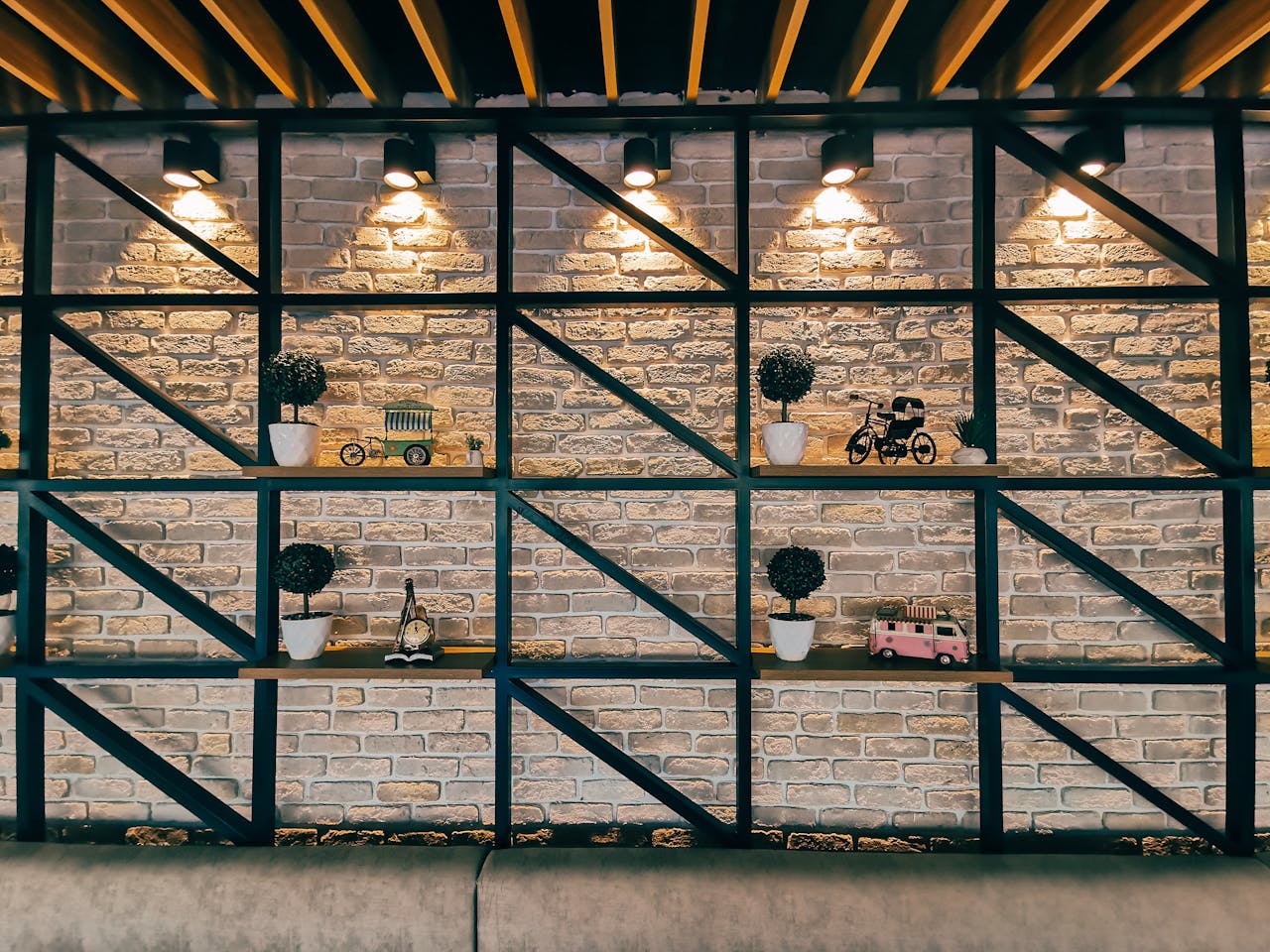 Mastering the First Impression: Your intriguing post title goes here Stylish interior with a brick wall featuring decorative shelves and warm lighting.